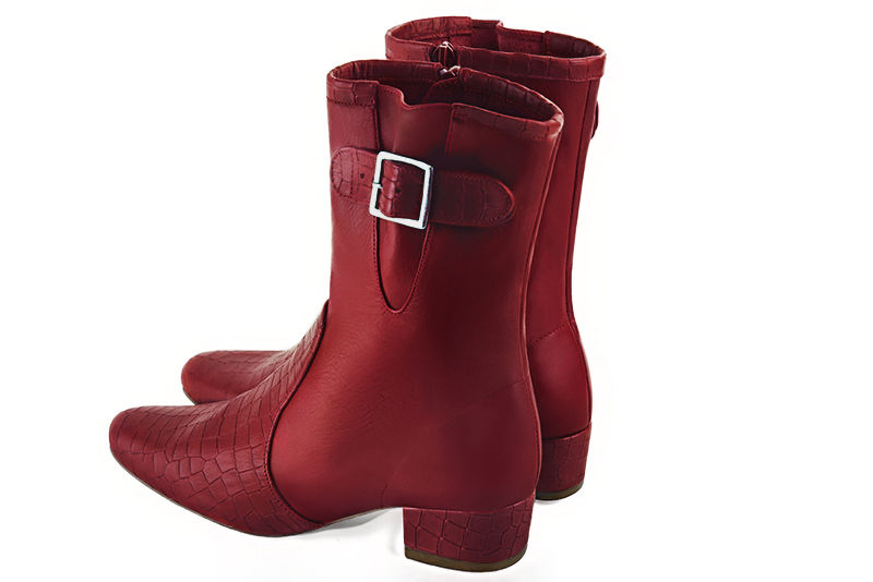 Burgundy red women's ankle boots with buckles on the sides. Round toe. Low block heels. Rear view - Florence KOOIJMAN